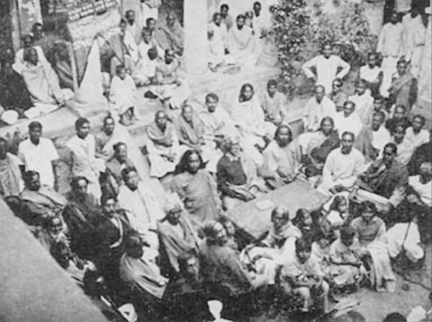 Last Solstice Festival celebrated by Sri Yukteswar, December, 1935. My Guru is seated in the center; I am at his right, in the large courtyard of his hermitage in Serampore.
