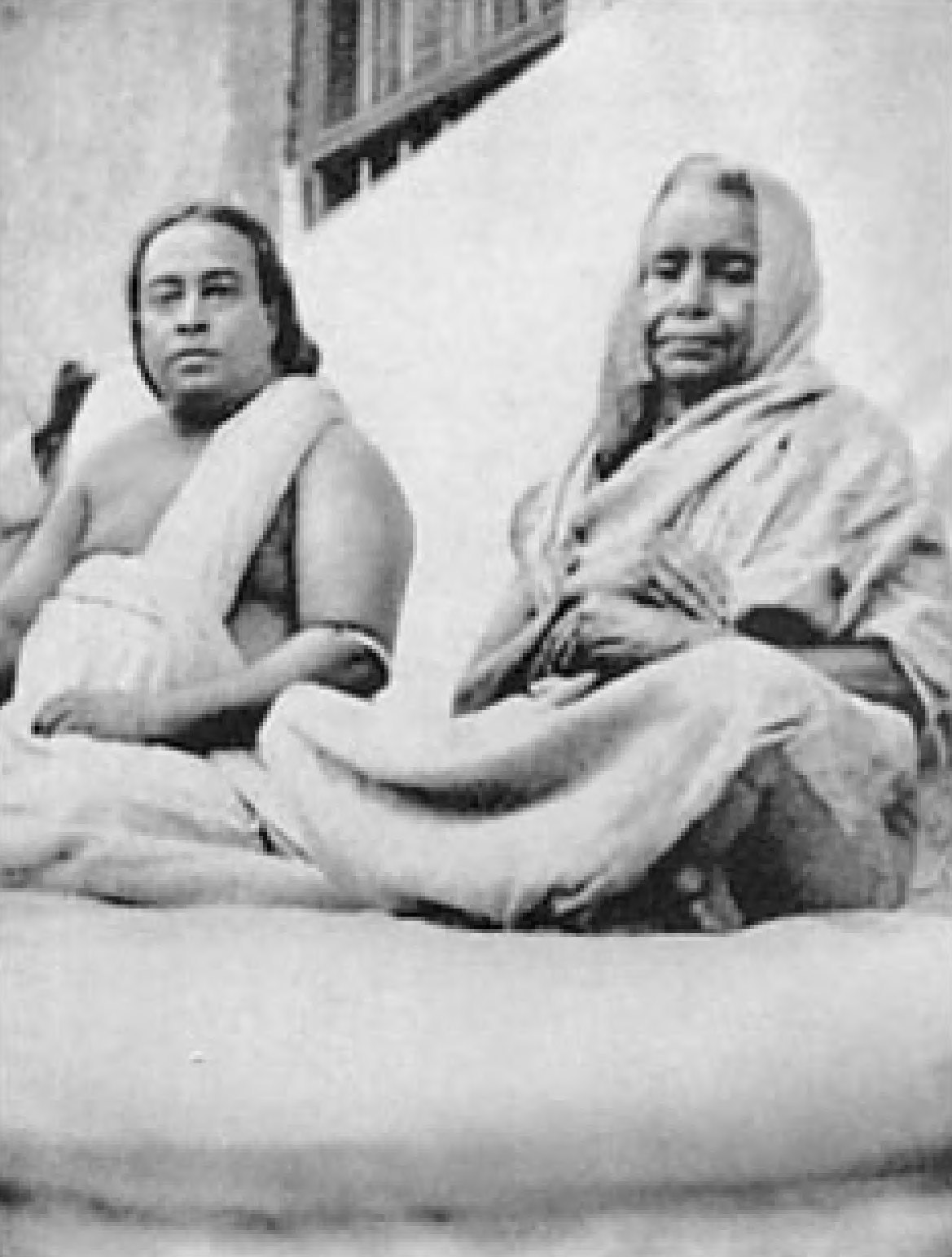 GIRI BALA
This great woman yogi has not taken food or drink since 1880. I am pictured with her, in 1936, at her home in the isolated Bengal village of Biur. Her non-eating state has been rigorously investigated by the Maharaja of Burdwan. She employs a certain yoga technique to recharge her body with cosmic energy from the ether, sun, and air.