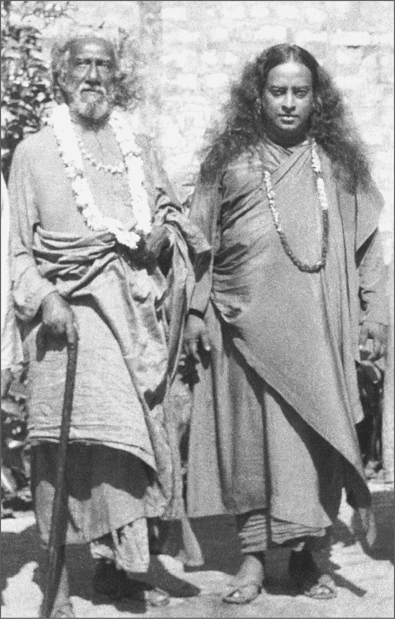 Sri Yukteswar and myself in Calcutta, 1935. He is carrying the gift umbrella-cane