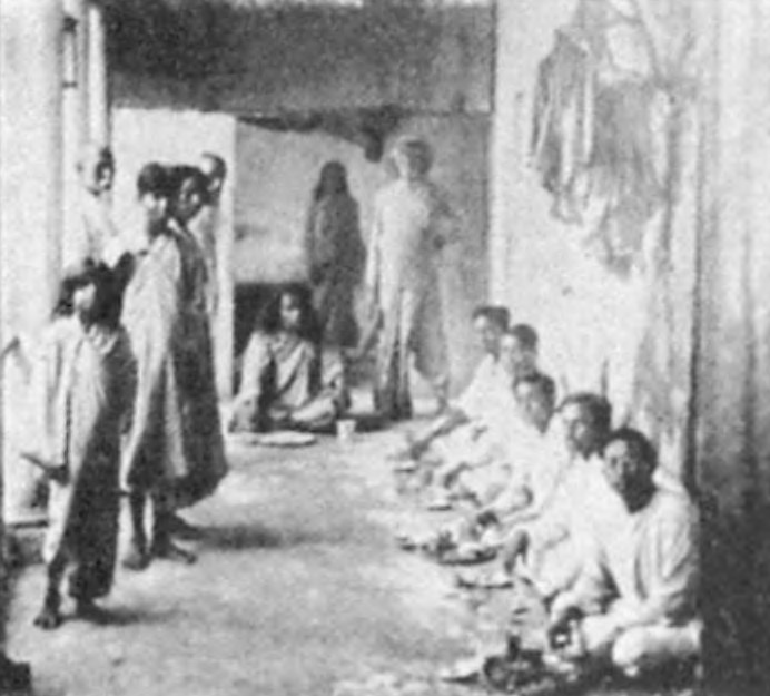 Second-floor dining patio of Sri Yukteswar’s Serampore hermitage. I am seated (in center) at my guru’s feet.