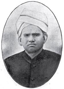 Oval portrait of Nelliappa Iyer in a light turban and dark buttoned coat.