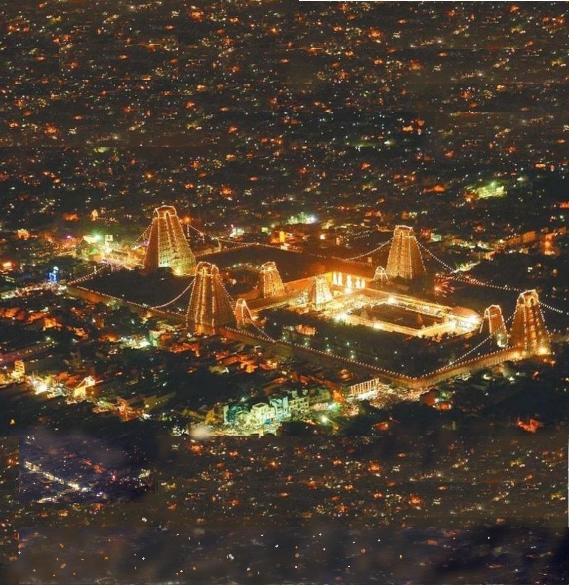Colour night photograph from above of the illuminated Arunachaleswara temple complex with its lit gopurams, surrounded by the lights of the town.