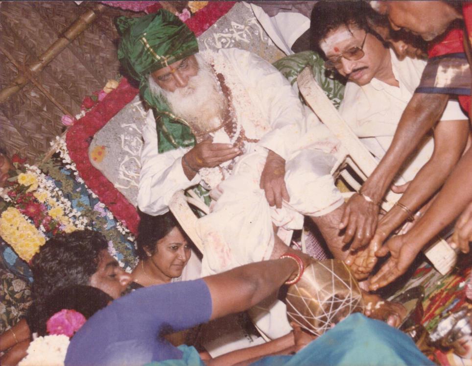 Smt.Vijaya and Janarthanan doing ‘Pada Puja’ to Yogiji (Anuradha is seated to the right of Yogiji and Ganesan, left)