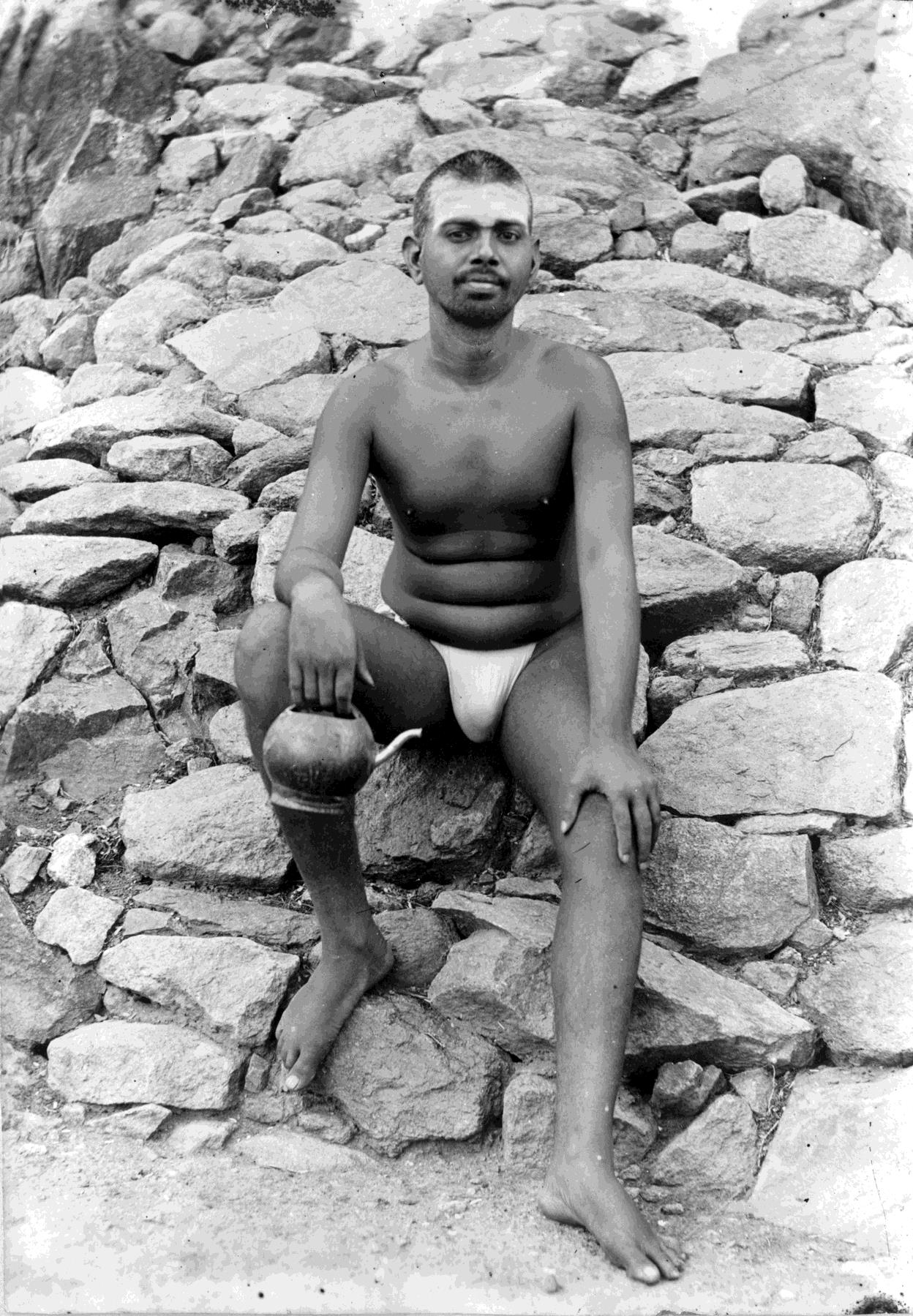 Sri Bhagavan seated outside Virupaksha Cave