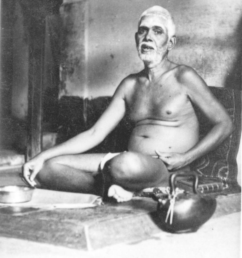 Sri Bhagavan seated in old dining hall after his meal