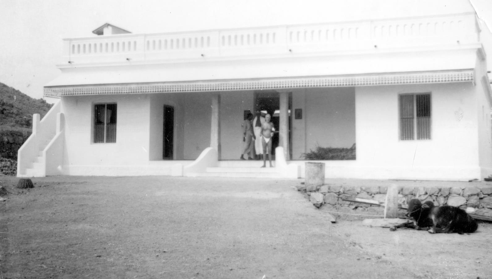Sri Bhagavan standing at the entrance of the cow shed built by Annamalai Swami