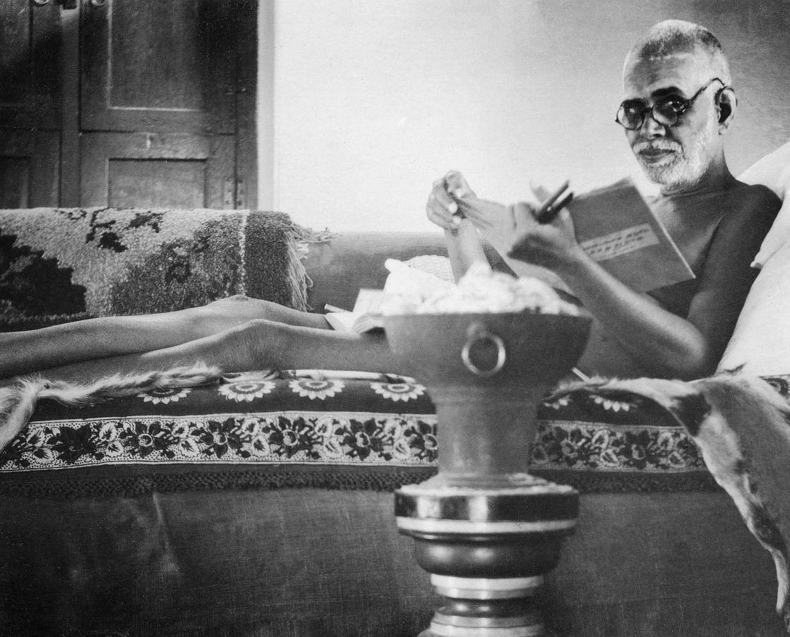 Bhagavan with glasses reading final proofs of ‘Ulladu Narpadu’