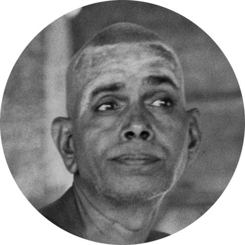 circular photo of Sri Bhagavan, head and shoulders, looking to the side