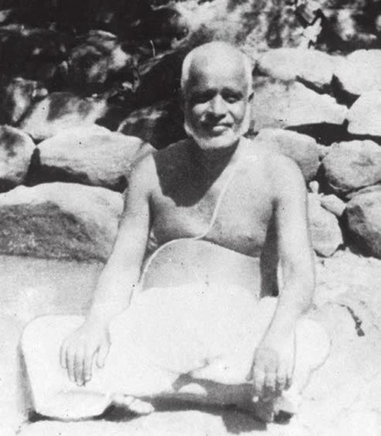 photograph: Munagala Venkataramiah seated among rocks