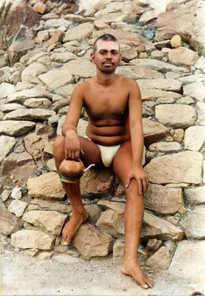 full-page photo of Sri Bhagavan seated outside the entrance to Virupaksha Cave
