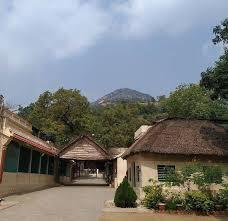 colour photo of Ashram buildings with the hill in the background