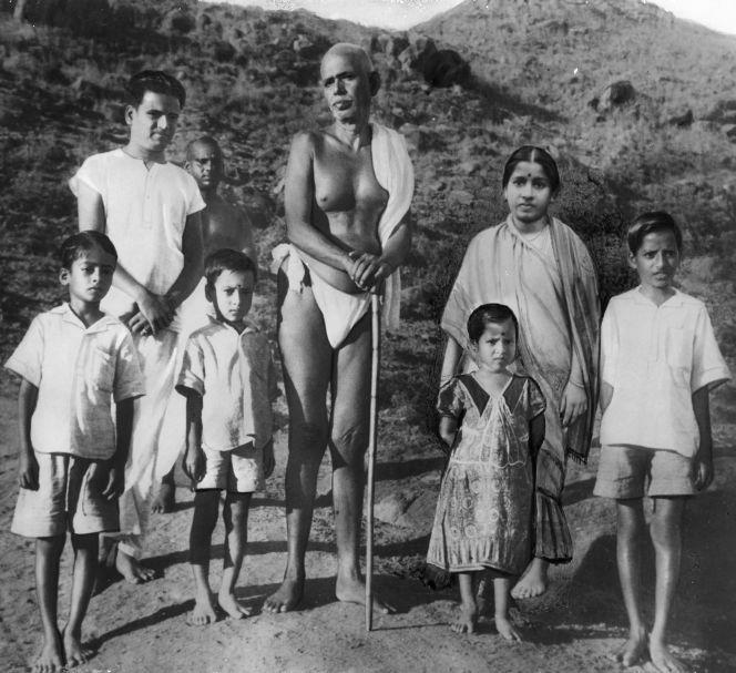 Sri Bhagavan standing with a group of children and adults