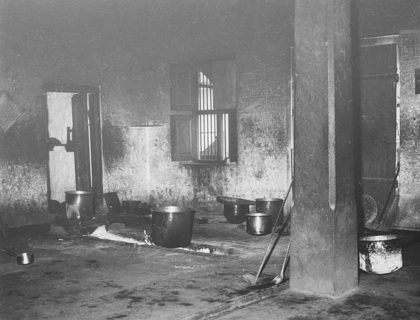 photo of the interior of the old Ashram kitchen, cooking vessels, pillar and hearth