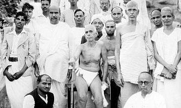 black-and-white group photo of Sri Bhagavan seated with devotees