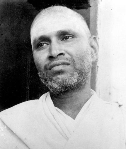 black-and-white portrait of a bearded man in white shawl (Sri Viswanatha Swami per caption)
