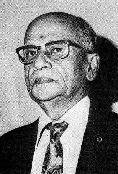 black-and-white portrait of an elderly man in glasses, suit and tie (K.K. Nambiar per caption)