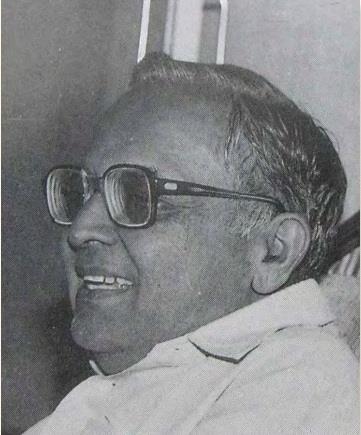 portrait photo of a man in glasses, three-quarter profile