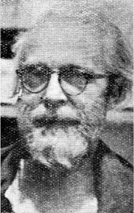 portrait photo of bearded elderly man in glasses
