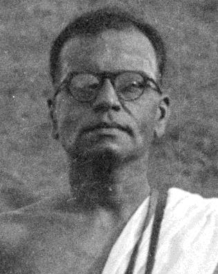 portrait photo of man in glasses, bare shoulders with white cloth