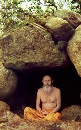 colour photo of Swami Abhishiktananda seated in a rock cave