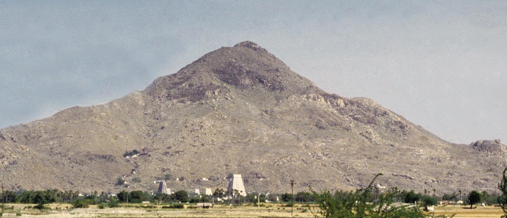 photo of Arunachala hill with temple gopurams at its foot