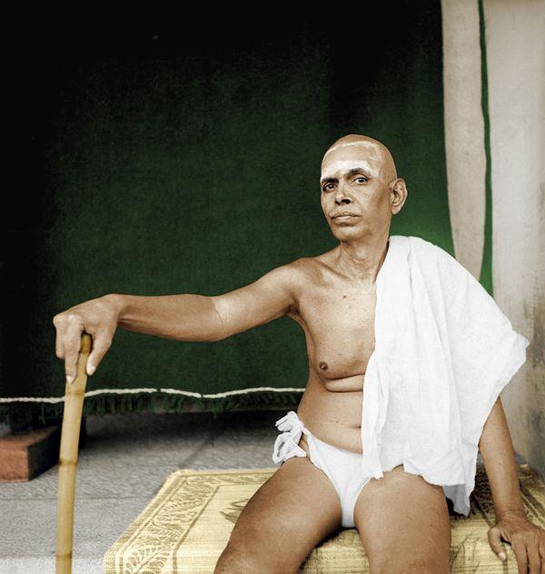 full-page colour photo of Sri Bhagavan seated with a walking stick, towel over his shoulder