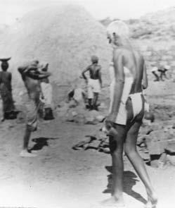 photo of Sri Bhagavan walking at a building site with workers