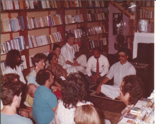 photo of a group seated in a book-lined room