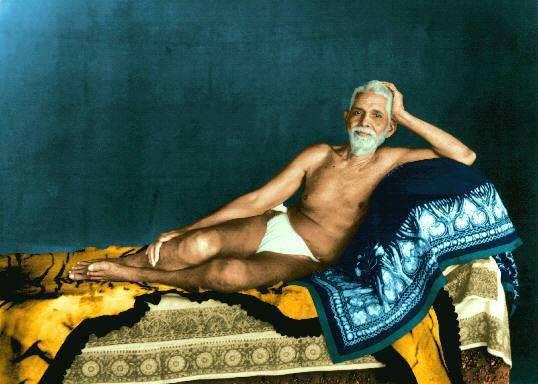 colour photograph of Sri Bhagavan reclining on a couch, head propped on his hand
