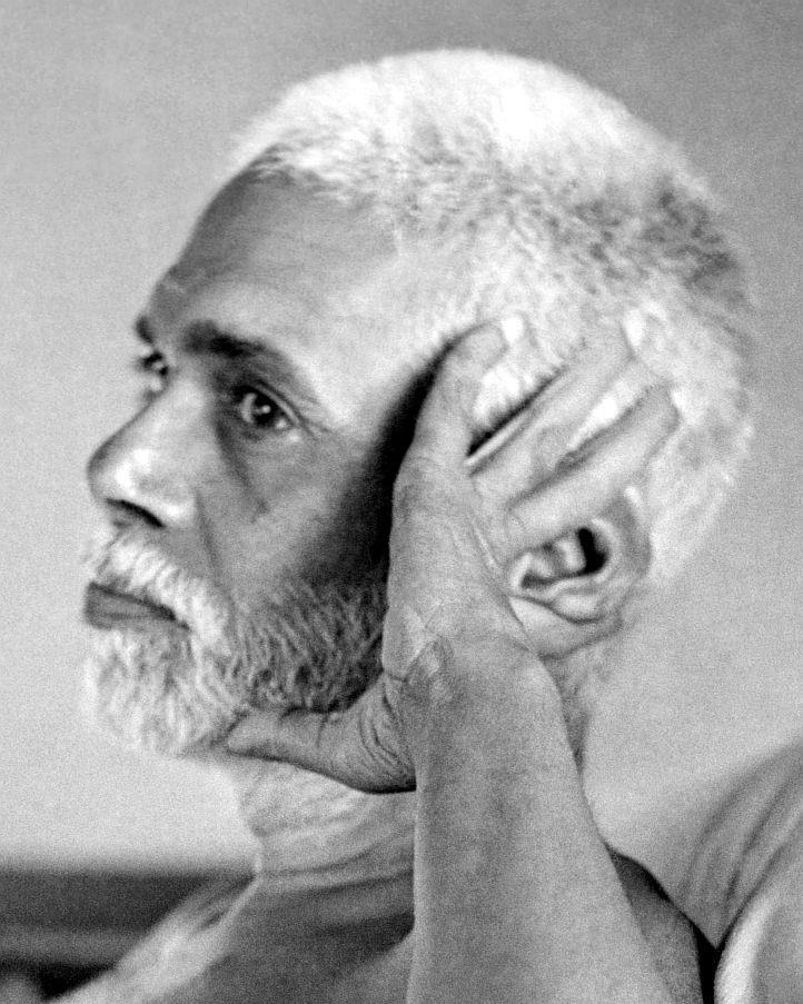 full-page photograph of Sri Bhagavan in profile, hand held to his cheek and ear