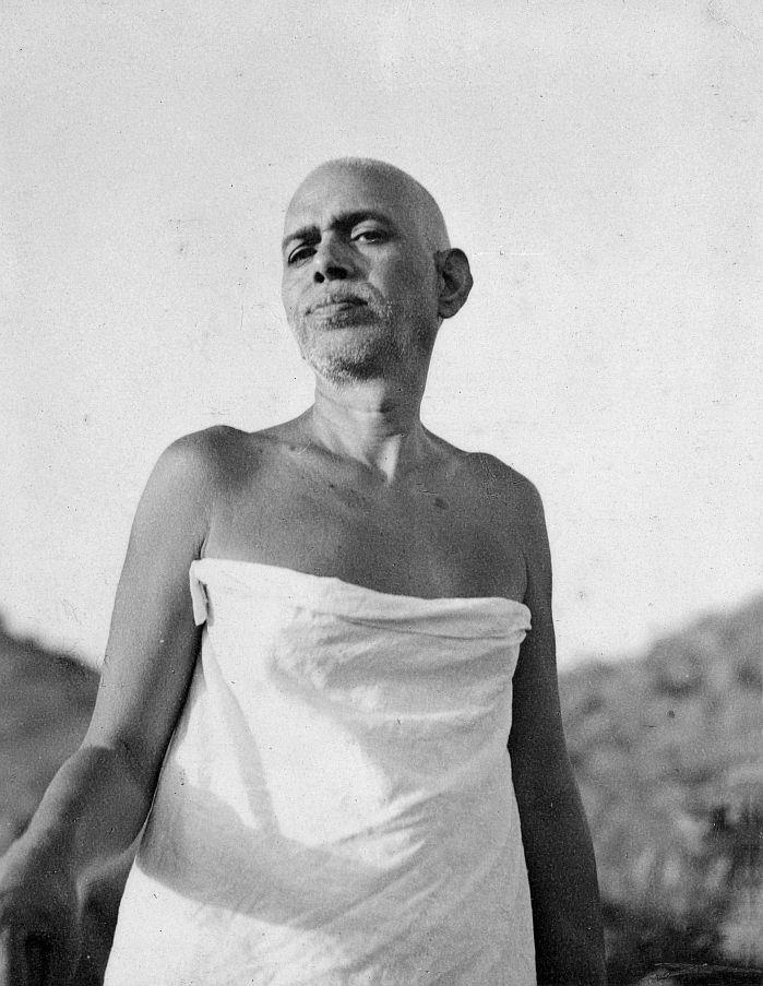 photograph of Sri Bhagavan standing outdoors, draped in a white cloth