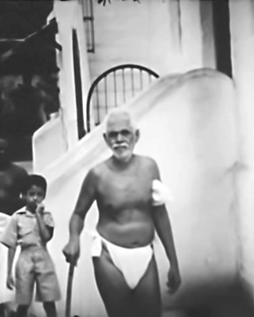 photo of a boy (Ganesan) following footsteps of Sri Bhagavan, still from an old movie